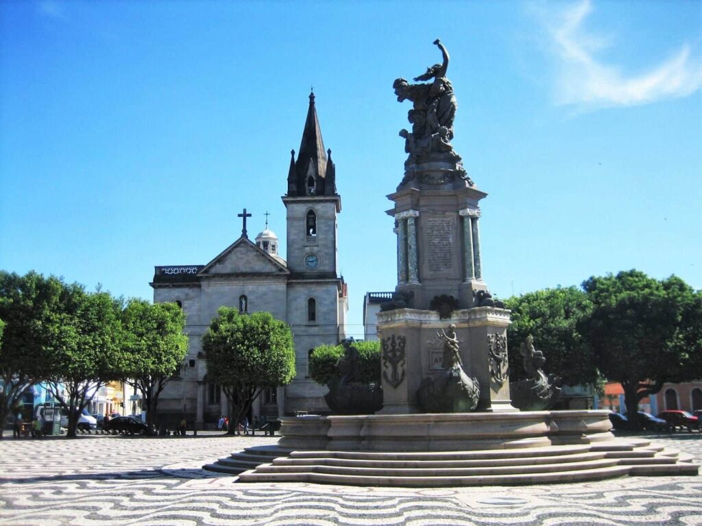 O Monumento à abertura dos Portos está na praça de uma igreja. A escultura lembra um pedestal em camadas, com uma escadaria.
