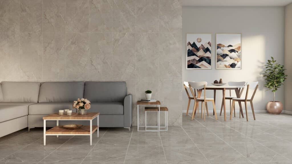Ambiente decorado com tons de cinza. O revestimento das paredes possui uma textura diferente do piso, mas todo o espaço segue o tema com o uso de uma única cor: cinza.